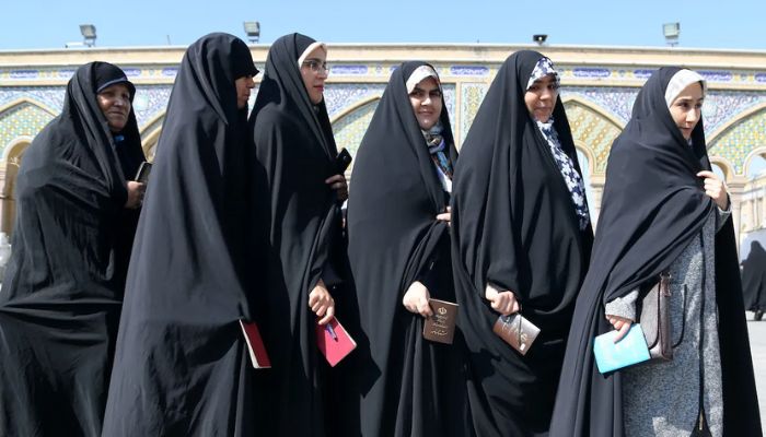 Iranian women wait to cast their ballots for the 11th Parliamentary elections at a polling station in Shah Abdol-Azim Shrine in Tehran on February 21, 2020. — AFP