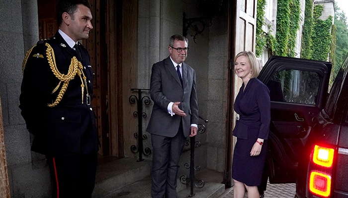 Newly elected leader of the Conservative party Liz Truss is greeted by Britains Queen Elizabeths Equerry Lieutenant Colonel Tom White and her Private Secretary Sir Edward Young as she arrives for an audience with Queen Elizabeth where she will be invited to become Prime Minister and form a new government, at Balmoral Castle, Scotland, Britain September 6, 2022. — Reuters
