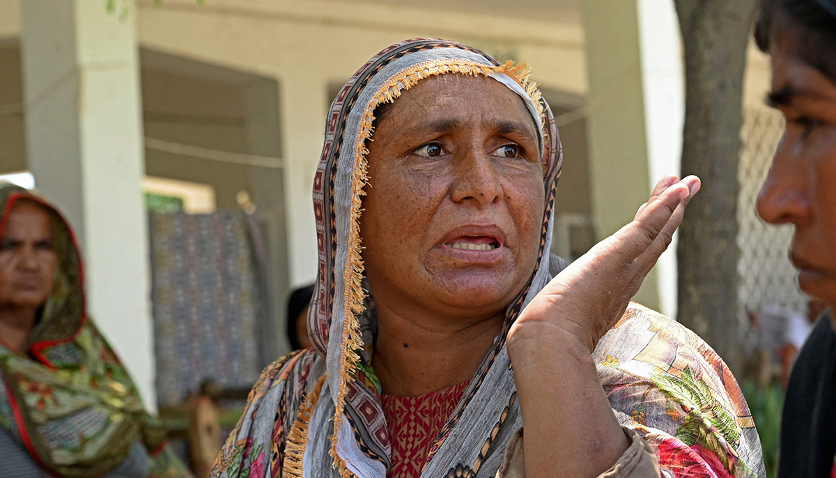 In this picture taken on September 3, 2022, Zebunnisa Bibi, a flood-affected woman speaks during an interview with AFP to explain her toilet issues at a makeshift camp in Fazilpur, Rajanpur district of Punjab province. — AFP