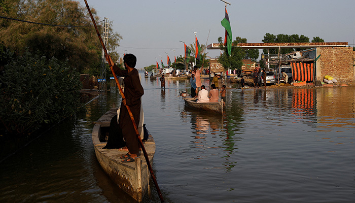 Residents use boats as they travel amid flood water, following rains and floods during the monsoon season in Bajara village, at the banks of Manchar lake, in Sehwan, Pakistan September 6, 2022. — Reuters