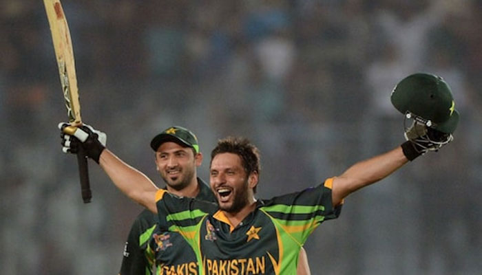 Shahid Afridi (R) celebrates after hitting a match winning six. — AFP