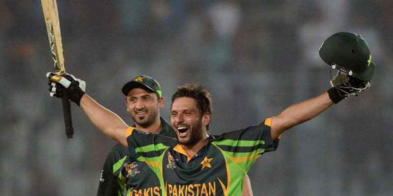 Shahid Afridi (R) celebrates after hitting a match winning six. — AFP