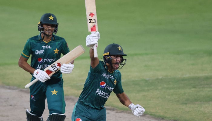 Naseem Shah (R) celebrates after hitting a boundary to win the Asia Cup Twenty20 international cricket Super Four match between Afghanistan and Pakistan at the Sharjah Cricket Stadium in Sharjah on September 7, 2022. — AFP