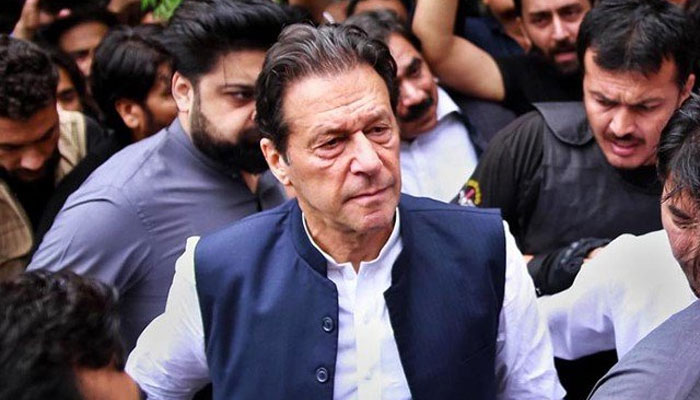 PTI Chairman Imran Khan seen surrounded by security personnel outside a court in Islamabad. — APP/File