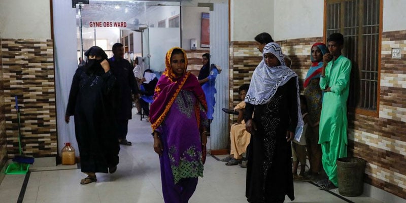 Nine-months-pregnant Dilshad Allahwarayo, 32, walks to get a medical checkup while being admitted to a hospital, following rains and floods during the monsoon season in Sehwan, Pakistan September 7, 2022.