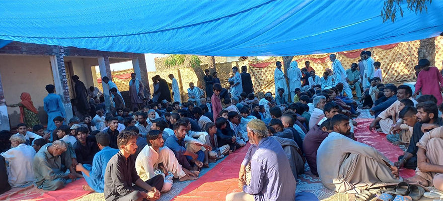 The flood affectees wait for food to be served in Khairpur, Sindh, following rains and floods during the monsoon season. — By Maria Mushtaq and Waheed Ali