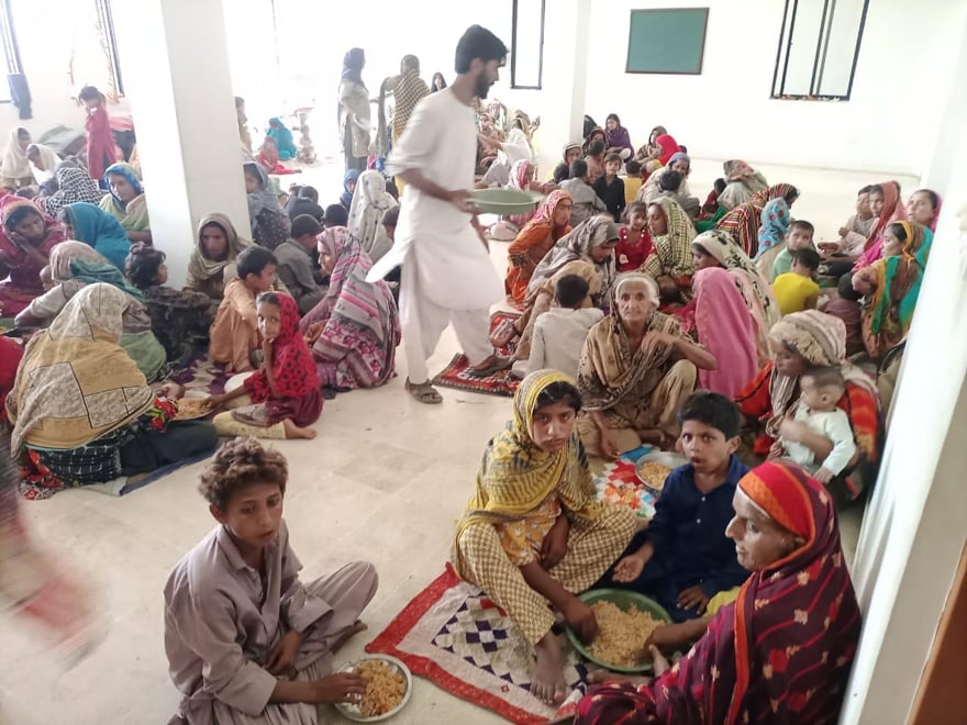 The flood affectees wait for food to be served in Khairpur, Sindh, following rains and floods during the monsoon season. — By Maria Mushtaq and Waheed Ali