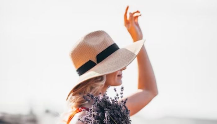 Representational image of a woman wearing a hat to protect herself from the Sun. —Unsplash