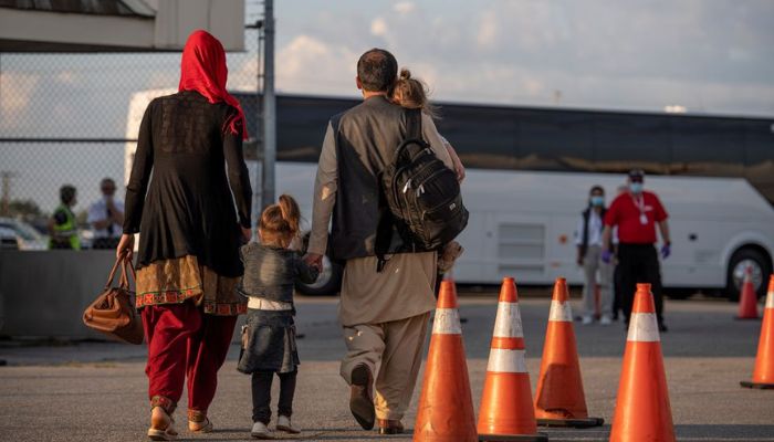 Afghan refugees who supported Canadas mission in Afghanistan prepare to board buses after arriving in Canada, at Toronto Pearson International Airport August 24, 2021. Picture taken August 24, 2021.— Reuters