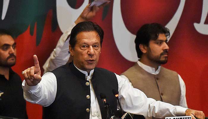 Imran Khan gestures as he addresses Pakistan Tehreek-e-Insaf party workers during a party convention in Lahore on April 27, 2022. -AFP