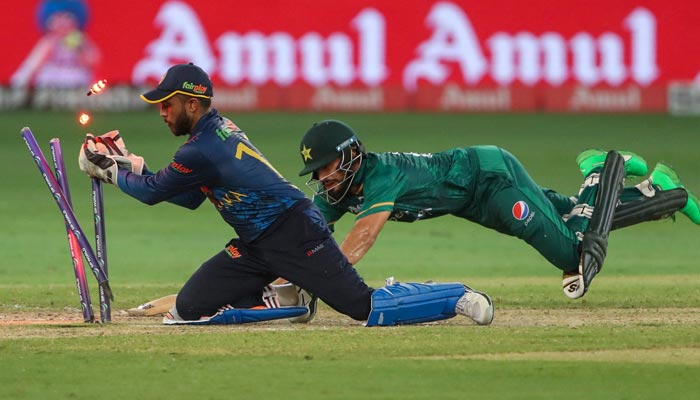 Sri Lankas wicketkeeper Kusal Mendis (L) breaks the wicket to runout Pakistans Mohammad Nawaz during the Asia Cup Twenty20 international cricket Super Four match between Pakistan and Sri Lanka at the Dubai International Cricket Stadium in Dubai on September 9, 2022. — AFP