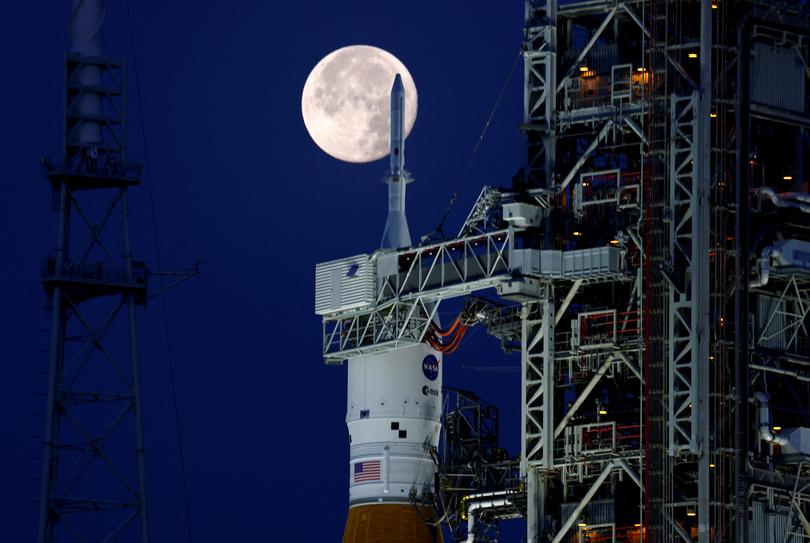 A full moon, known as the Strawberry Moon is shown with NASA?s next-generation moon rocket, the Space Launch System (SLS) Artemis 1, at the Kennedy Space Center in Cape Canaveral, Florida, U.S. June 15, 2022. — Reuters