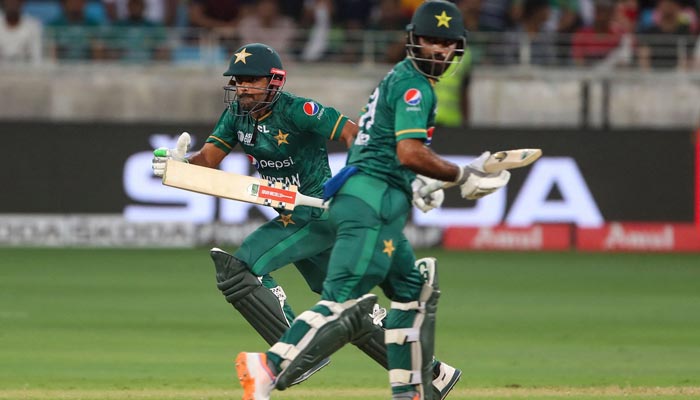 Pakistans captain Babar Azam (L) and teammate Fakhar Zaman take a run during the Asia Cup Twenty20 international cricket Super Four match between Pakistan and Sri Lanka at the Dubai International Cricket Stadium in Dubai on September 9, 2022. — AFP