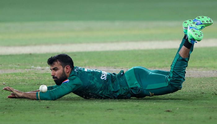 Pakistans Shadab Khan dives to field the ball during the Asia Cup Twenty20 international cricket final match between Pakistan and Sri Lanka at the Dubai International Cricket Stadium in Dubai on September 11, 2022. — AFP