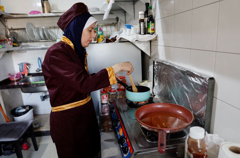 Palestinian chef Amena Al-Hayek cooks a meal at the newly-opened women-only restaurant, called Sabaia VIP, in Gaza City September 6, 2022. — Reuters