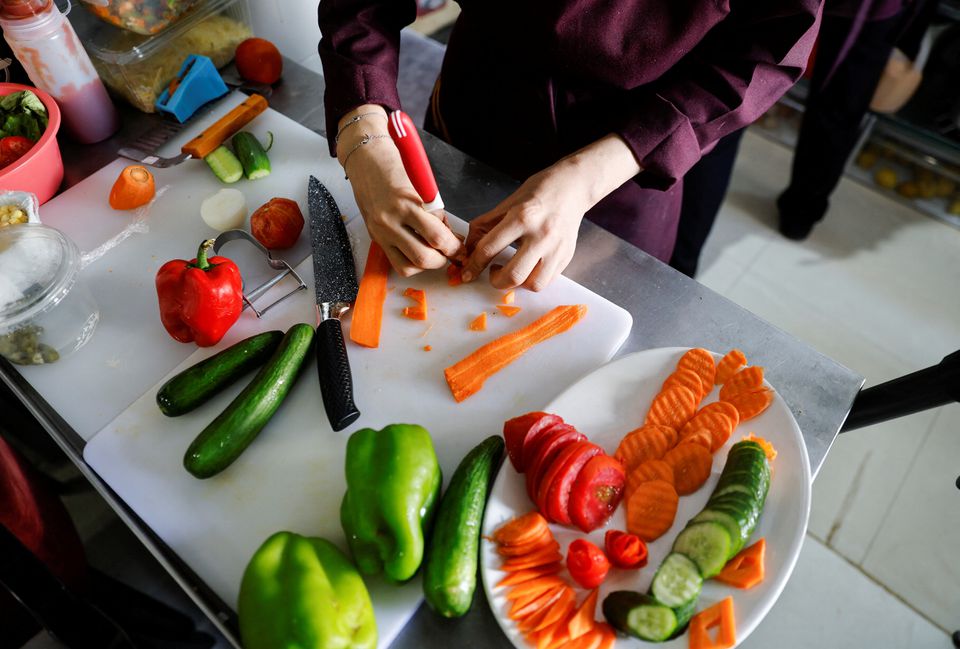 Palestinian chef Amena Al-Hayek cooks a meal at the newly-opened women-only restaurant, called Sabaia VIP, in Gaza City September 6, 2022. — Reuters