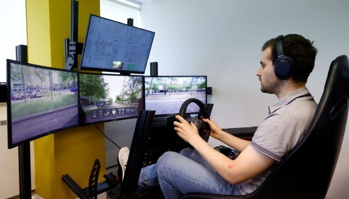 An operator controls a Fetch driverless car from the office of Imperium Drive, during driverless car trials, in Milton Keynes, Britain, June 8, 2022. — Reuters