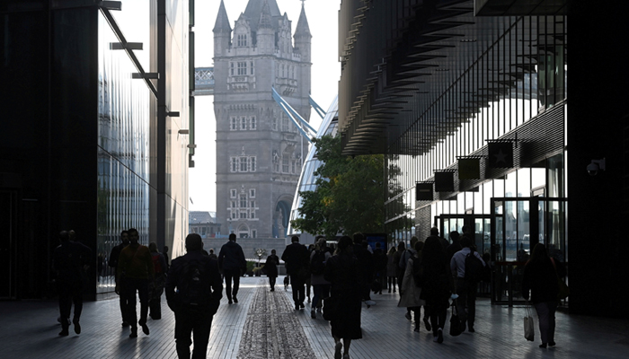 Workers walk towards Tower Bridge in London, Britain, September 15, 2021. — Reuters