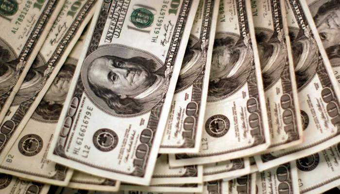 Four thousand U.S. dollars are counted out by a banker counting currency at a bank in Westminster, Colorado November 3, 2009. — Reuters