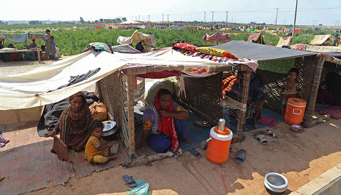 Internally displaced people take shelter in their makeshift tent in the flood-hit Hyderabad city of Sindh province on September 11, 2022. — AFP