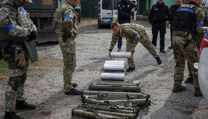 A police sapper carries a cassette with anti-personnel mines POM-3 after return from the village of Udy, recently liberated by Ukrainian Armed Forces, in the town of Zolochiv, Kharkiv region, Ukraine September 12, 2022. — Reuters