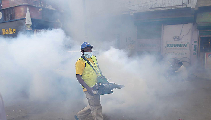 Health workers spray anti-dengue for protecting people from dengue fever in Karachi in this undated photo. — INP/File