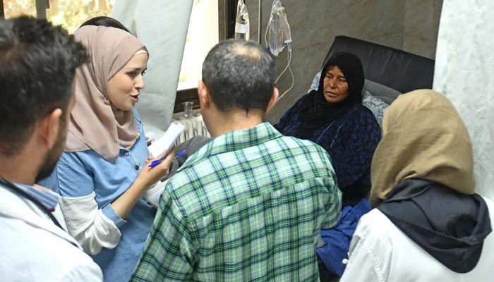 A woman receives treatment for cholera at a hospital in Syrias main northern city of Aleppo. — AFP