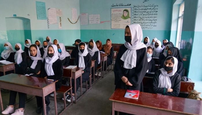 Girls attend a class after their school reopened in Kabul on 23 March 2022. The Taliban ordered girls secondary schools to shut down just hours later. — AFP