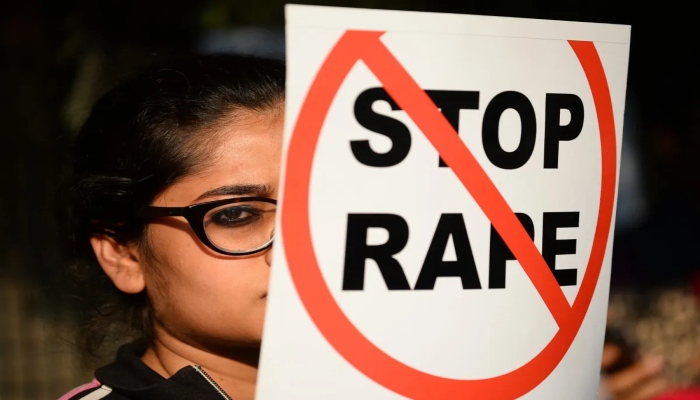 A representational image showing a person holding a placard saying stop rape. — AFP/ File
