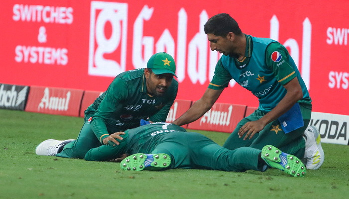 Pakistans captain Babar Azam (L) checks teammate Shadab Khan after he collided with Asif Ali in an attempt to take a catch during the Asia Cup Twenty20 international cricket final match between Pakistan and Sri Lanka at the Dubai International Cricket Stadium in Dubai on September 11, 2022. -AFP