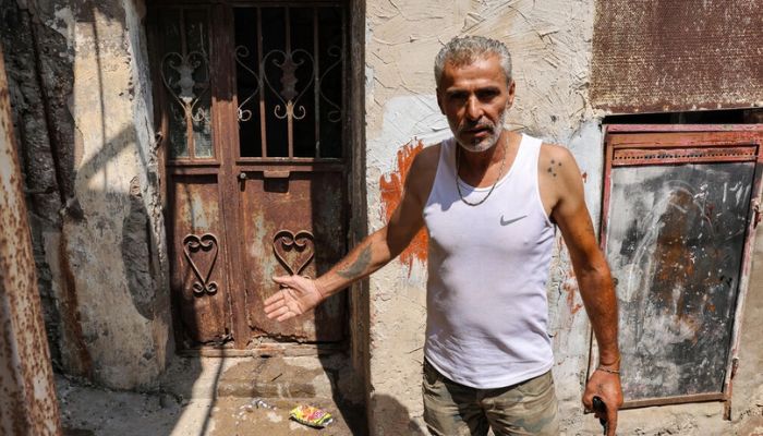 Najib al-Khatib, 52, indicates a place that was laden with corpses after the Sabra and Shatila massacre 40 years ago.