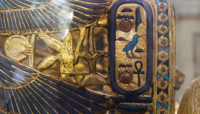 This picture taken on May 3, 2022 shows a view of the gilded throne of the ancient Egyptian New Kingdom Pharaoh Tutankhamun (1334-1325 BC), found in 1922 at his tomb KV62 in Luxor and on display at the Egyptian Museum in the capital Cairo, this side showing the cartouche depicting his birth name as Tutankhaten in Egyptian hieroglyphs before the name change to Tutankhamun. Ahead of the bicentenary of the deciphering of the Rosetta Stone -- which unlocked the key to reading ancient hieroglyphs -- and the 100th anniversary of Carter´s earth-shattering discovery, Egyptians are demanding that their contributions to the discoveries be recognised and artefacts abroad returned.