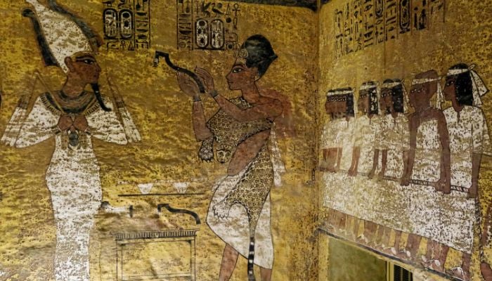 This picture taken on January 18, 2022 shows a view of the interior of the exact replica of KV62, the tomb of Pharaoh Tutankhamun (1332-1323 BC), located by the former residence of the tomb discoverer British archaeologist Howard Carter in Egypt´s southern city of Luxor, depicting the boy Pharaoh (L) in the form of Osiris having the opening of the mouth ceremony performed on him by vizier Ay. Ahead of the bicentenary of the deciphering of the Rosetta Stone -- which unlocked the key to reading ancient hieroglyphs -- and the 100th anniversary of Carter´s earth-shattering discovery, Egyptians are demanding that their contributions to the discoveries be recognised and artefacts abroad returned.