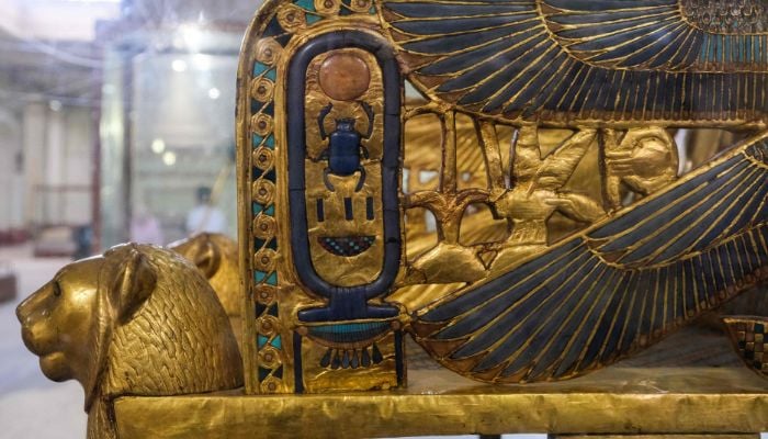 This picture taken on May 3, 2022 shows a view of the gilded throne of the ancient Egyptian New Kingdom Pharaoh Tutankhamun (1334-1325 BC), found in 1922 at his tomb in Luxor and on display, at the Egyptian Museum in the capital Cairo, this side showing the cartouche depicting his throne name Neb-Khepru-Ra in Egyptian hieroglyphs. Ahead of the bicentenary of the deciphering of the Rosetta Stone -- which unlocked the key to reading ancient hieroglyphs -- and the 100th anniversary of Carter´s earth-shattering discovery, Egyptians are demanding that their contributions to the discoveries be recognised and artefacts abroad returned.