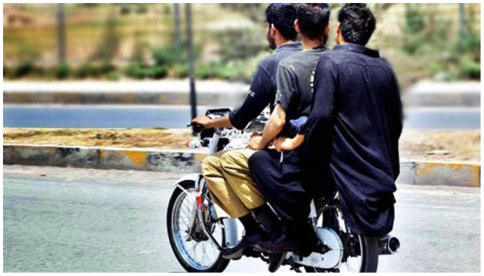 Image showing three people riding on a motorcycle. For Representation only — APP/File