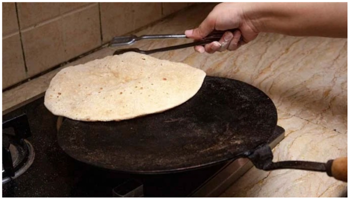 Person baking a roti over a tawa. Image for representation only. —  Indiatimes