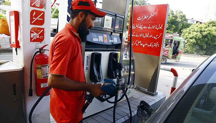 A fuel station worker fills petrol in a vehicle at a petrol pump in Karachi on September 01, 2022. — PPI