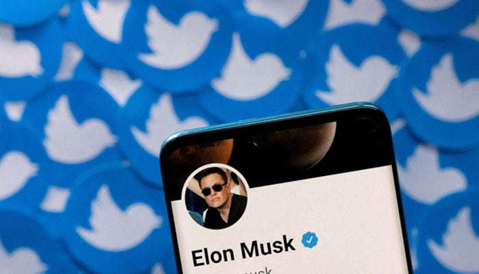 Elon Musks Twitter profile is seen on a smartphone placed on printed Twitter logos in this picture illustration taken April 28, 2022. — Reuters