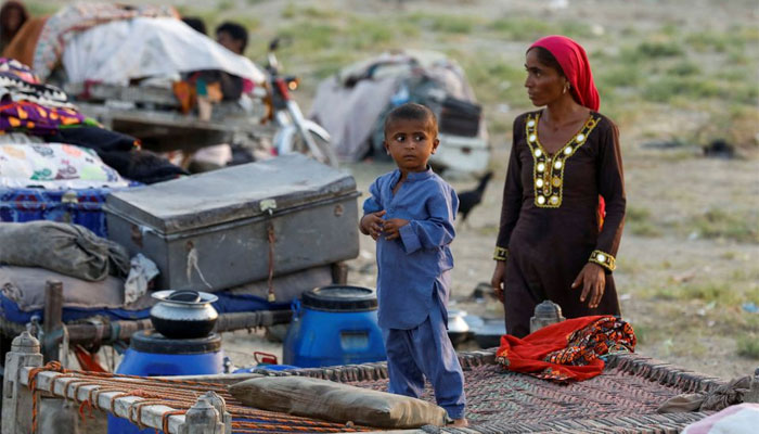 A boy and a woman, who became displaced, take refuge in a camp, following rains and floods during the monsoon season in Sehwan, Pakistan September 15, 2022. — Reuters