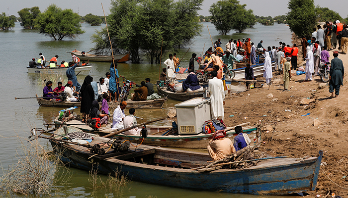 Flood victims use boats to reach their villages, following rains and floods during the monsoon season in Sehwan, Pakistan, September 16, 2022. — Reuters