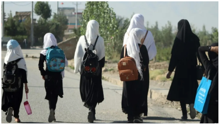 Image showing some schoolgirls walking on a road. — AFP/ File
