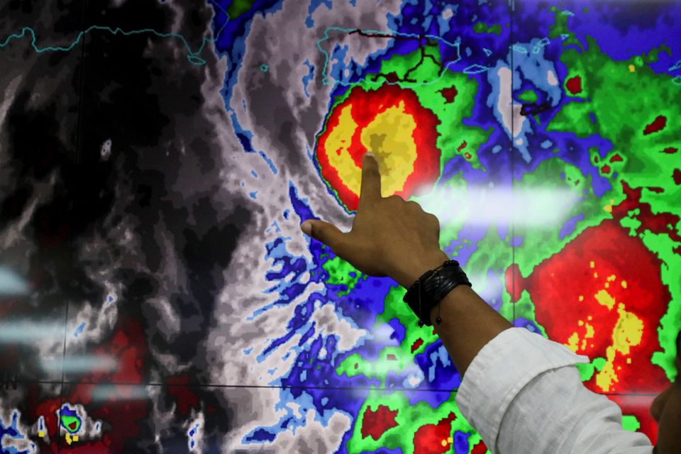 A member of the Emergency Operations Committee (COE) monitors the trajectory of Hurricane Fiona in Santo Domingo, Dominican Republic, September 18, 2022.