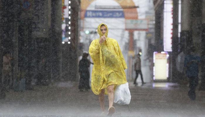A man walks on the street in heavy rain and wind caused by Typhoon Nanmadol in Kagoshima on Japans southernmost main island of Kyushu September 18, 2022. — Reuters