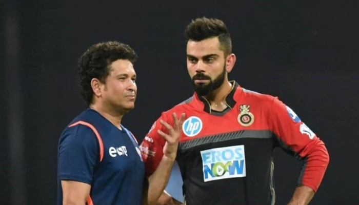 Cricketing great Sachin Tendulkar (left) speaks to Indian batter Virat Kohli during the Indian Premier League in this undated photo. — AFP/File