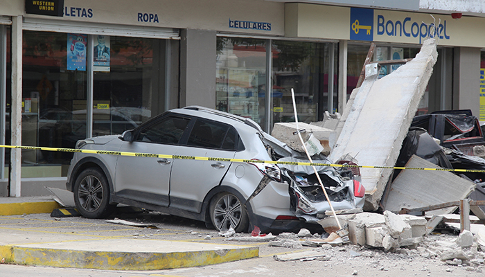 Vehicles damaged by the collapse of the facade of a department store during an earthquake are pictured in Manzanillo, Mexico September 19, 2022. — Reuters