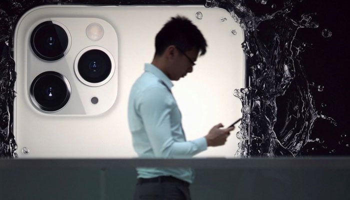 A man walks next to an advertisement for Apples new iPhone 11 Pro at the Apple Store in IFC, Central district, Hong Kong, China October 10, 2019. —Reuters