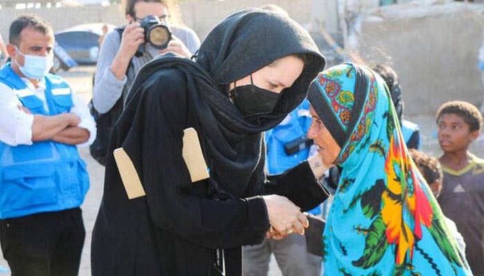 UNHCR Goodwill Ambassador Angelina Jolie interacts with a flood victim. — Twitter/@PTVNewsOfficial