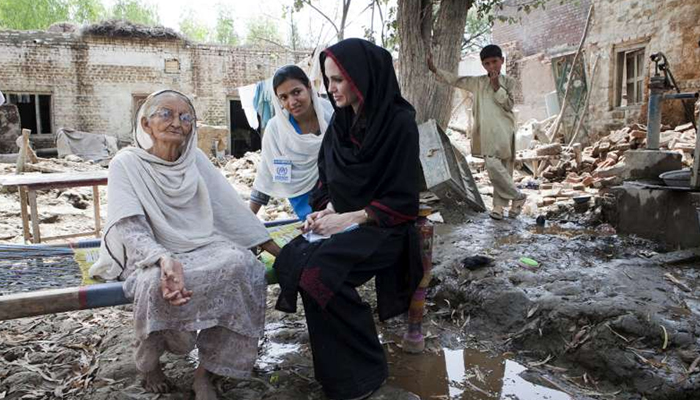 UNHCR Goodwill Ambassador Angelina Jolie talks to an old lady at her flood-damaged home in the northern Pakistani village of Mohib Bandi in this undated photo. — UNHCR