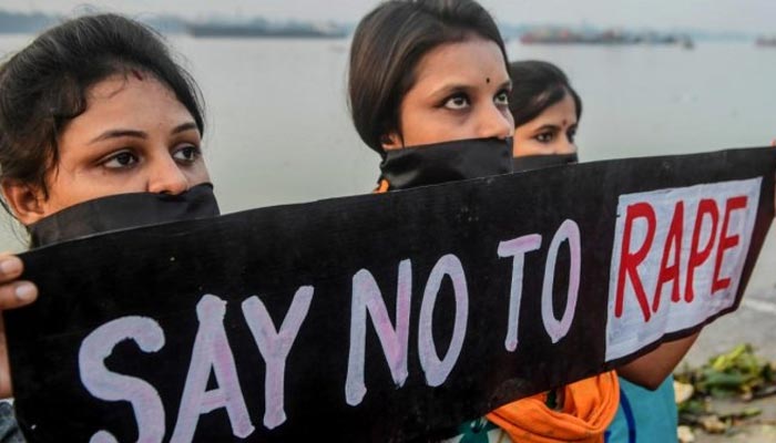 Representational image of protesters holding a banner reading Say no to rape. — AFP/File