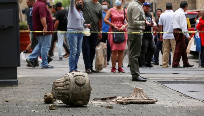 People gesture at an area cordoned off by police after an ornament fell off from a church during an earthquake, in Guadalajara, Mexico September 19, 2022. — Reuters